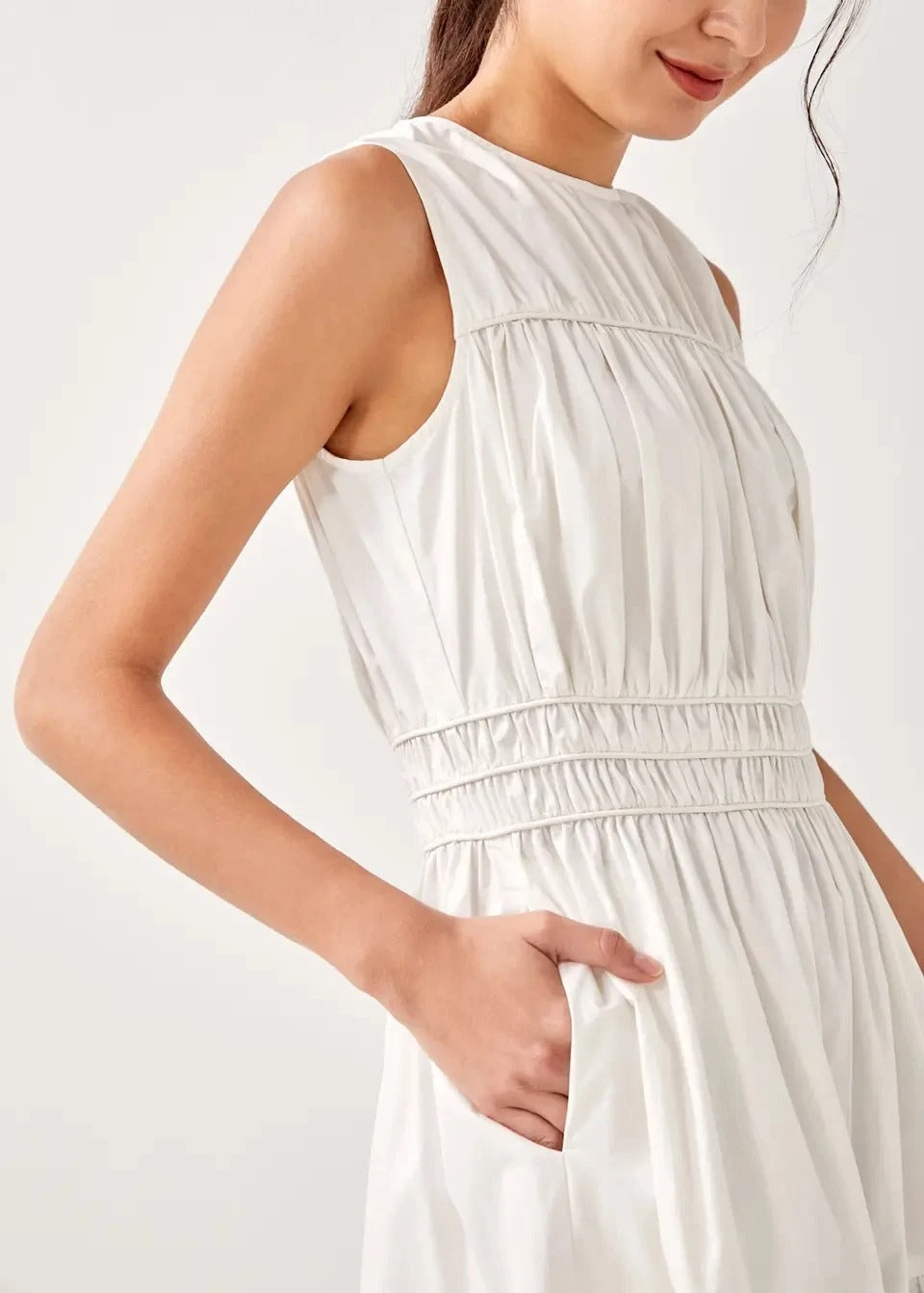 White sleeveless midi dress with gathered waist and tiered skirt