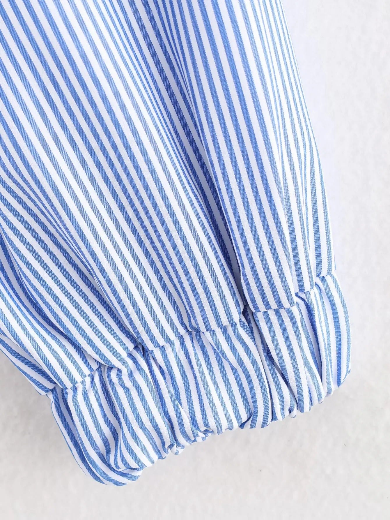 Light blue striped zip jacket with red heart patch
