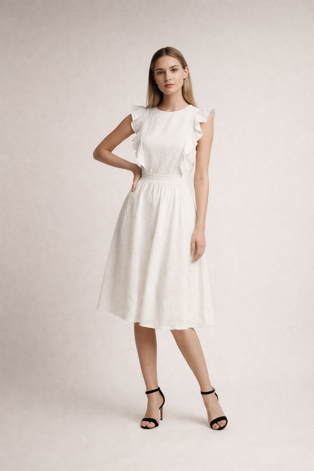 White midi dress with ruffle shoulders and textured fabric